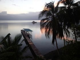 Bocas del Toro Panama dock and ocean at sunset with palm tree – Best Places In The World To Retire – International Living